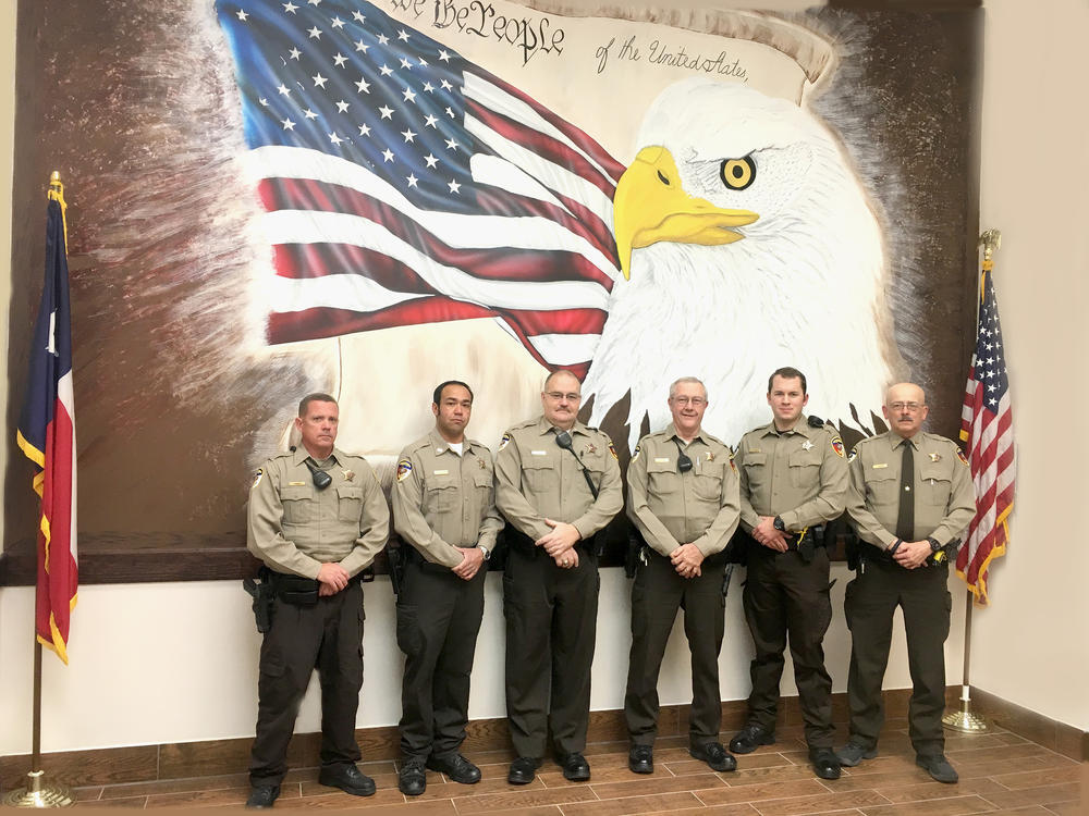 Reserve deputies in front of bald eagle painting